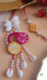 Thread Floral Design Rakhi With Cowrie Shells